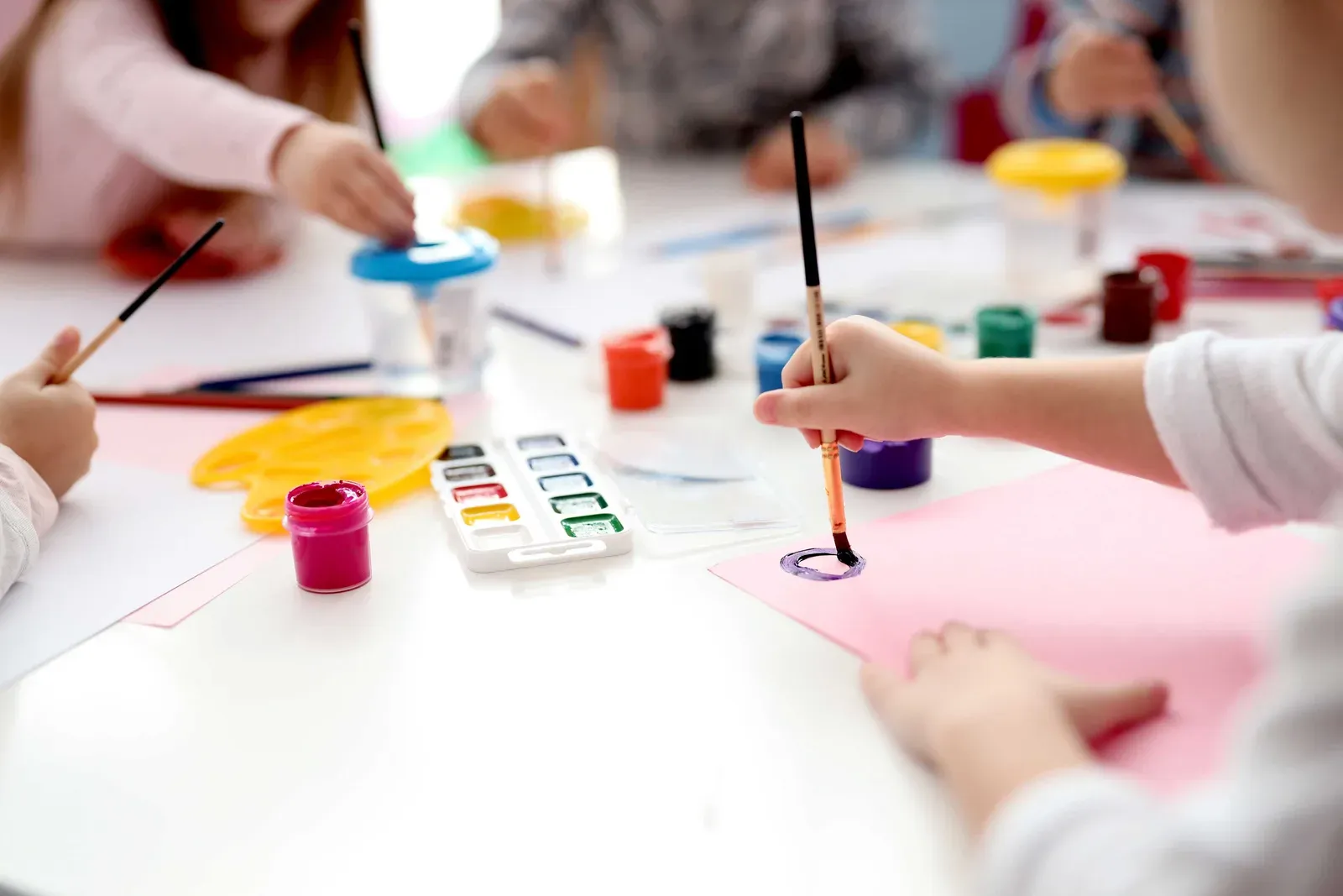 Children painting together at an Arty Afternoons workshop